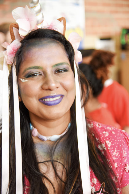 Celebrating culture at United to Serve. Female students with long white ribbons in her hair and purple lipstick